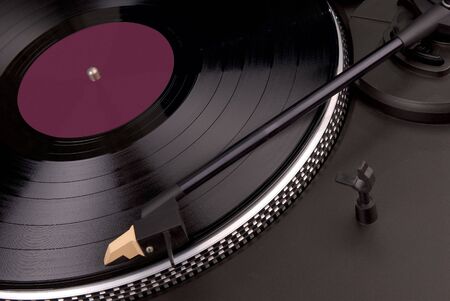 a record playing on a turntable with the needle on the record with the label of the record removed