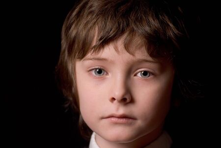 attractive young boy up-close isolated over a black background                                の写真素材