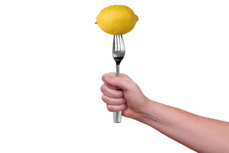 Lemon on fork isolated over a white backgroundの写真素材