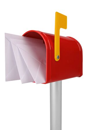 A standard red mailbox with a yellowmail and flag isolated over whiteの写真素材
