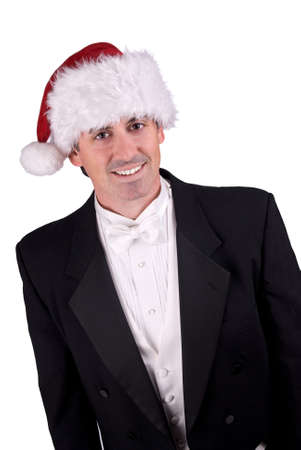 Adult man wearing a Christmas hat and a tuxedo isolated over whiteの写真素材