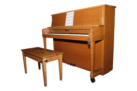 Old upright piano and bench isolated over white background with clipping pathの写真素材