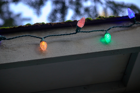 string of colorful lights along the edge of a roof
