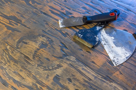 paint scrapers and puddy knives on wood