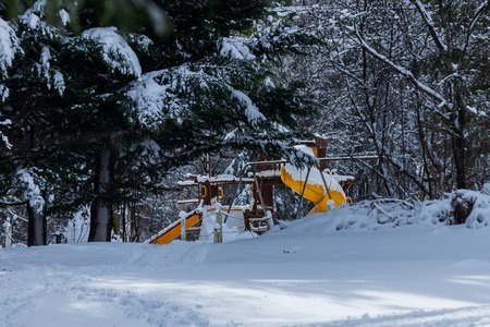 park play place covered in a thick layer of snowの写真素材
