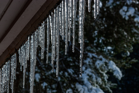 lots of icicles frozen to a roofの写真素材
