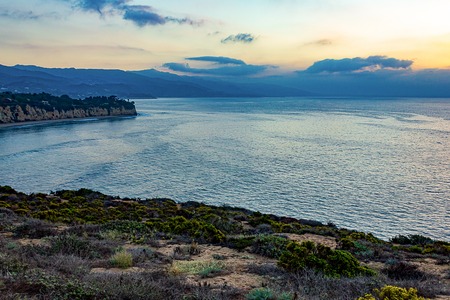 pacific ocean sunrise from cliff with peninsullaの写真素材