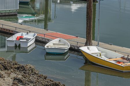 small rental boats docked along wooden walkway out on water
