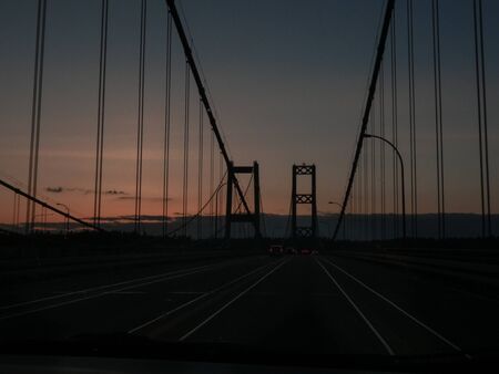 narrows bridge with traffic flowing along at sunset