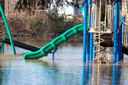an unintentional water slide in a flooded parkの写真素材