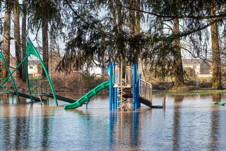 a flooded public park with a playgroundの写真素材