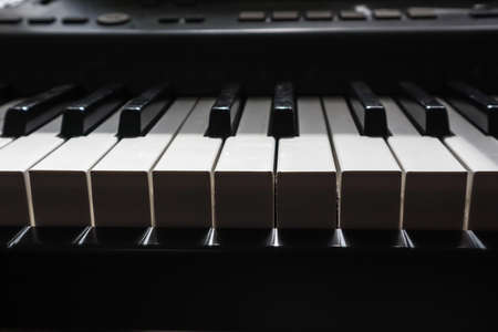 piano keys in bright light and dark shadowの写真素材
