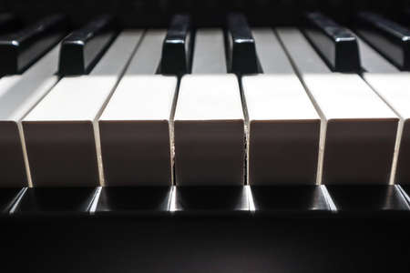 piano keys in bright light and dark shadowの写真素材