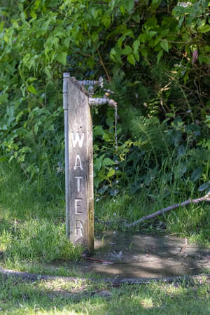 fresh drinking water tap on hiking trail in parkの写真素材