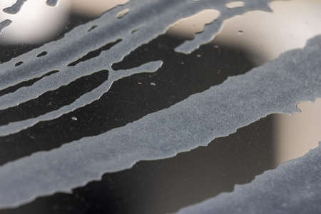 white foamy soap suds on a clear window