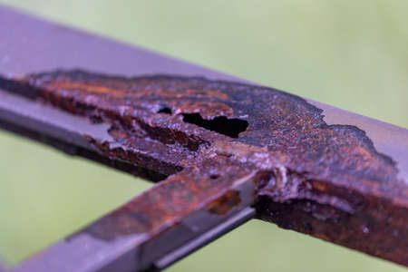 metal frame with hole corroded by water