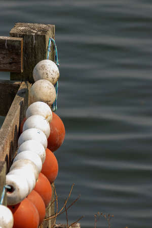 white and orange floats on strings over water