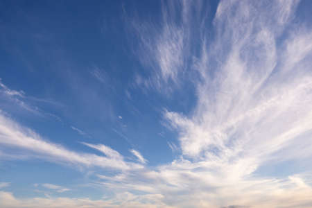 bright white clouds streaming though a blue skyの写真素材