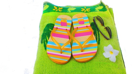 Beach slippers,towel and sunglassesの写真素材