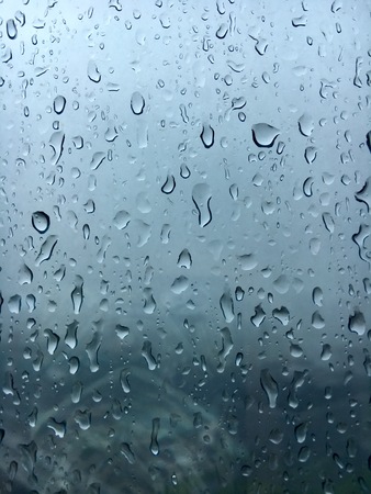 Raindrops beside glass windowsの写真素材