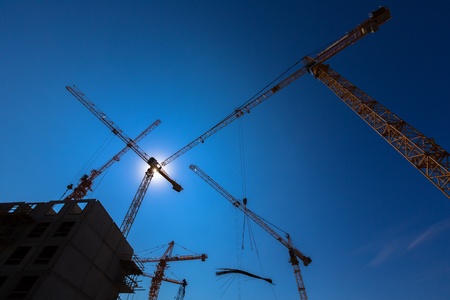 Construction site with cranes on sky background