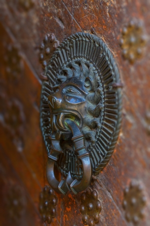 Ancient weathered door fragment with metal lion head handle  Tallinn, Estonia