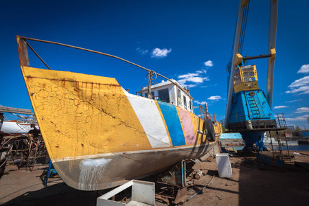 Old boat, raised on the land for restorationの写真素材