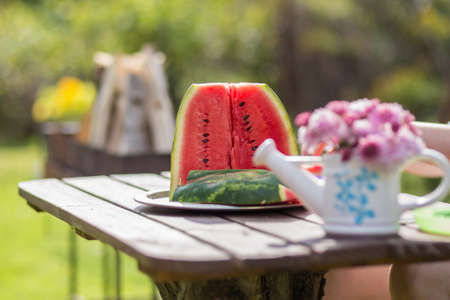 Closeup still life watermelon on brown wooden table with bokeh nature on backgroundの写真素材