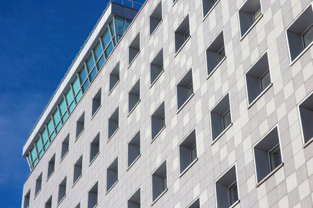 A beautiful modern building set against a deep blue sky.の写真素材