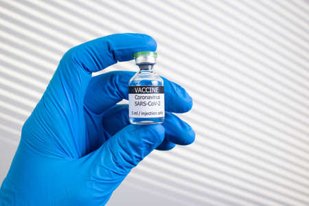 Development and creation of a coronavirus vaccine COVID-19. Coronavirus Vaccine concept in hand of doctor vaccine jar. Vaccine Concept of fight against coronavirus.の写真素材
