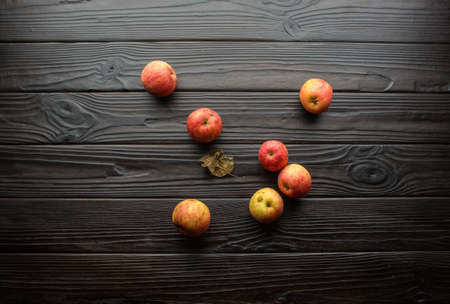 Top view of colorful apples lying on dark textured tableの写真素材