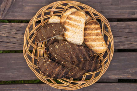 Wicker platter with slices of grilled breadの写真素材
