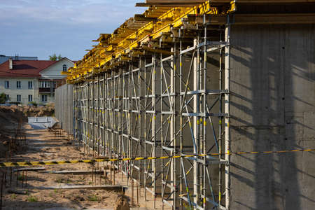 Construction of a new modern building. Lots of scaffolding and formwork for pouring concrete.の写真素材