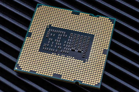 Close-up of the underside of a modern processor with many gold-plated pinsの写真素材