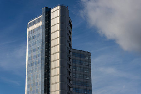 Bottom view of a beautiful tall modern office building against the sky