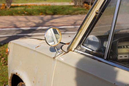 Close-up of an old rusty vintage car from the USSR abandoned on the streetの写真素材