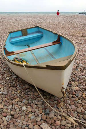 Boat parked on a pebble beach in Devonの写真素材