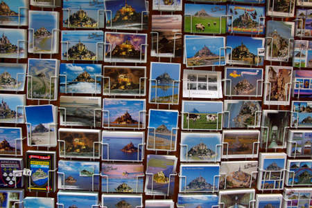 Postcards of the Mont Saint Michel (France) displayed in a store. No logos.