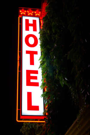 Lighted hotel sign in the night (red and white).の写真素材