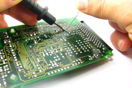 Detail view of an electronic board being repaired.