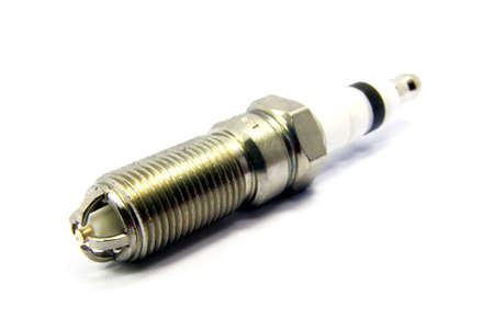 Detail view of an engine spark plugs over white background.