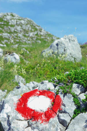 Red and white hike symbol in the mountains,の写真素材