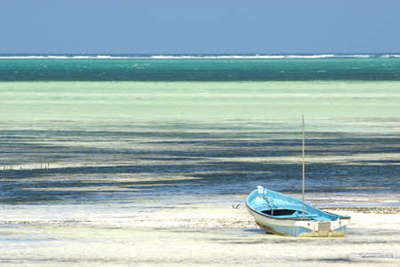 Image of a traditional boat on turquoise beachの写真素材