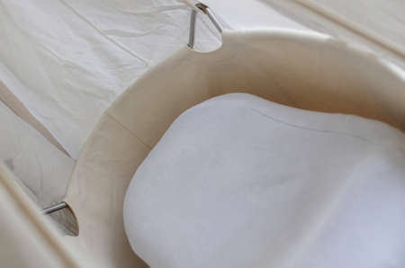 Image of a beige babys bed の写真素材