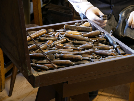 Vintage cobbler workshop with shoe making tools.