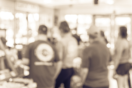 Vintage tone blurred image line of customers at check-out counter grocery in USA. Concept of busy shoppers waiting at local farmer market. Business concept, bokeh lightの写真素材