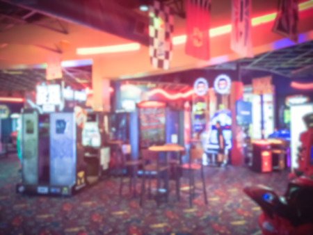 Vintage blurred motion game room at entertainment complex in Dallas, Texas, USA. Abstract arcade area background.の写真素材