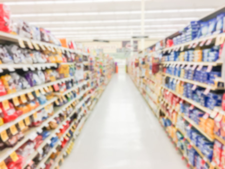 Defocused snack time treats aisle on display with price tags at department.の写真素材