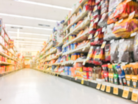 Defocused snack time treats aisle on display with price tags at department.の写真素材