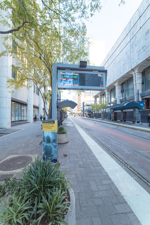 Light rail train station with passenger waiting in downtown Dallのeditorial素材